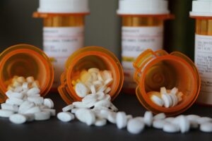 Photo of open prescription pill bottles symbolizing opioid use in chronic pain management