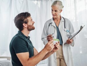 Doctor explaining a prescription to a patient during a hospital consultation, representing physician-patient communication