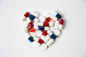 Heart shape made from various pills and statin medications, symbolizing overuse of statins in elderly patients