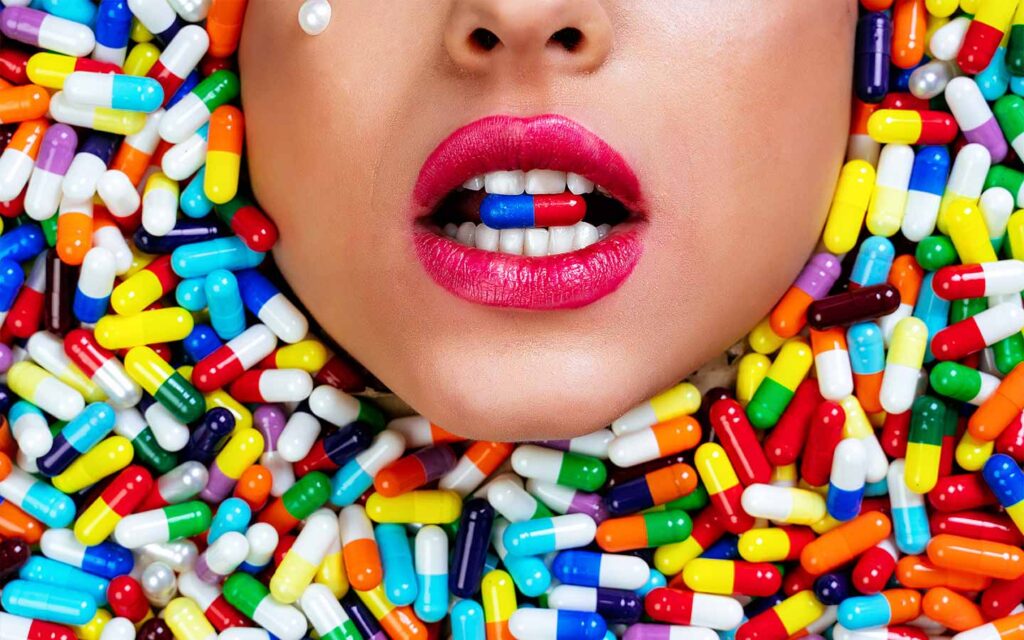 Close-up of a person surrounded by pills, illustrating direct-to-consumer drug advertising effects and disease branding