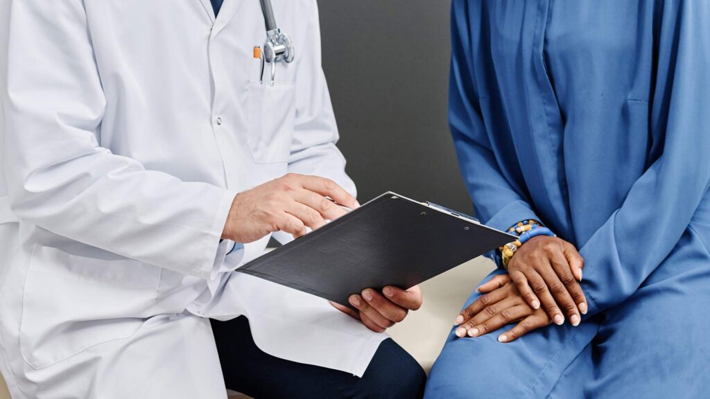 Doctor reviewing information with a patient, illustrating shared decision-making amid a state medical board investigation and guideline pressure