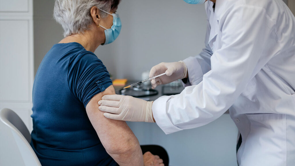 Older adult receiving a shingles vaccine injection, illustrating Shingrix risks, benefits, and shared decision-making