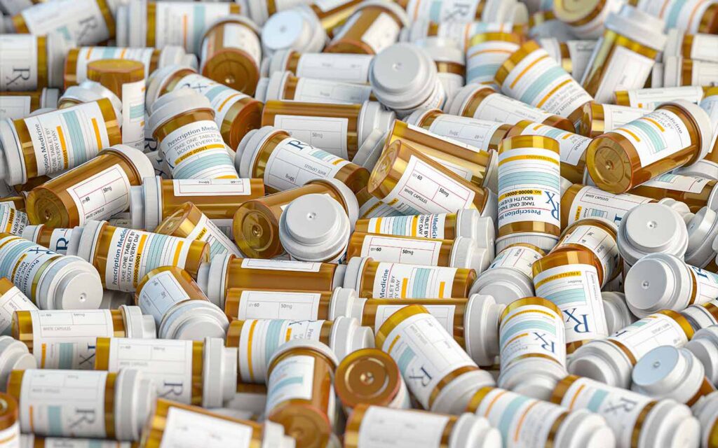 Pile of prescription pill bottles, illustrating Zetia (ezetimibe) escalation and why composite “events” can mislead outcomes in seniors